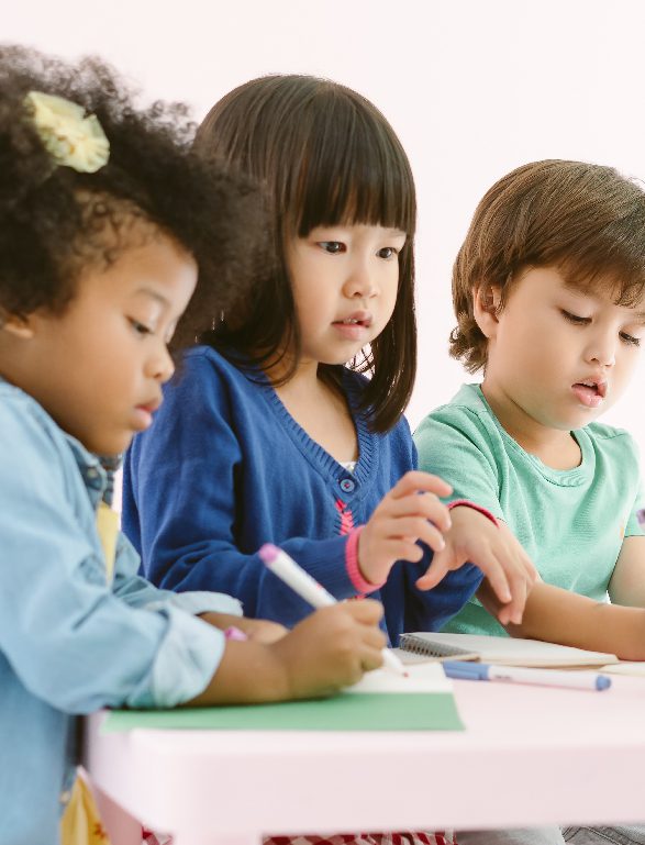 children drawing at a table